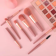 An 8-piece mini makeup brush set with a light pink handle and synthetic bristles, arranged neatly.