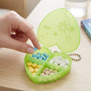 Compact pill organizer held in hand showing four compartments