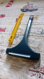 Versatile window cleaning brush being used to clean the mesh on a car window.