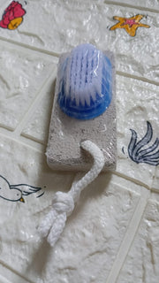 Top-down view of the XcelCraft pumice stone foot scrubber, highlighting its two effective surfaces.