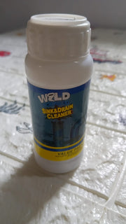 Drain cleaning powder effectively removing blockages from a kitchen sink.