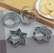 A 12-piece stainless steel cookie cutter set featuring heart, star, round, and flower shapes.