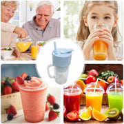 Fresh smoothie in the portable juicer cup with a straw, placed on a table.