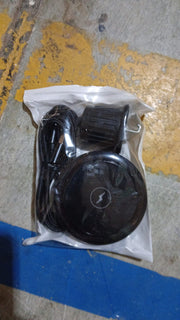 User demonstrating the compact design of the magnetic wireless car charger.