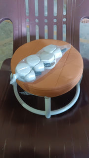 Another view of the white low height rolling stool, emphasizing its compact size.