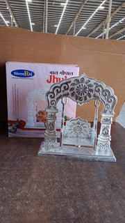 Handcrafted silver Bal Gopal Jhula swing displayed indoors for devotional use