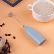 Close-up of coffee milk frother machine blending coffee and milk