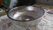 Angled shot of the versatile kitchen colander, ready for use.