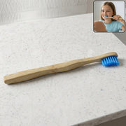 Sustainable wooden toothbrush with soft blue bristles and natural handle