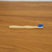 Wooden toothbrush in natural setting, eco-friendly material