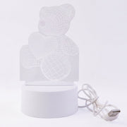 Teddy bear LED Night Lamp glowing softly in dark room