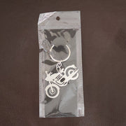 Lifestyle shot of a motorcycle silhouette metal keychain attached to a set of keys.