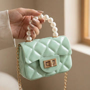 Elegant mini handbag with classic pearl handle and detailed quilted pattern