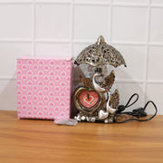 Decorative table lamp with swan couple and clock on living room table