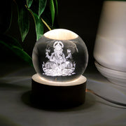 Detailed view of the illuminated 3D Ganpati idol inside the crystal ball, showing its radiant effect.