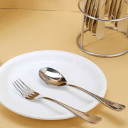 Utensils of stainless steel cutlery set neatly arranged on table