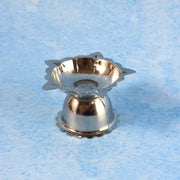 Close-up of metal sunflower design diya stand with durable finish