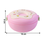 A single Donut Lunch Box and its matching spoon on a clean surface.
