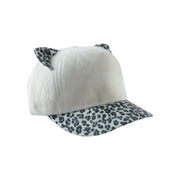 Winter fur cap styled on mannequin, playful winter accessory