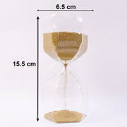 Smooth yellow sand flowing inside an elegant glass hourglass timer.