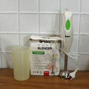 Electric hand blender in kitchen setting blending fresh ingredients