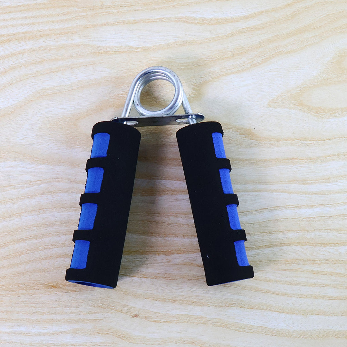 Hand grip exerciser showing foam padded ergonomic handles