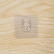 Wall hook on wooden door with transparent adhesive
