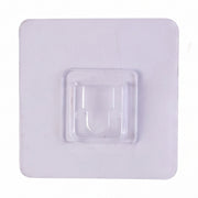 Transparent wall hook attached to a smooth surface for organization.
