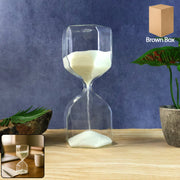 Clear glass hourglass timer with white sand showing elegant design for desk decor