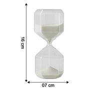 Close-up of glass timer with fine white sand flowing inside for precise visual countdown