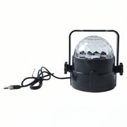 Hand holding the small USB powered star projector light, highlighting its compact size.