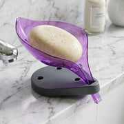 Angled view of a green leaf shape soap tray showing water drainage.