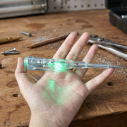 Digital voltage tester pen detecting electricity on electrical outlet with LED lights