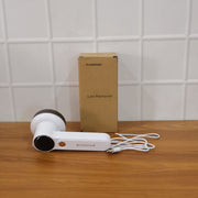 Fabric lint remover in use on home textile for effective fuzz removal