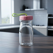 Glass bottle with vibrant silicone lid and convenient carrying handle