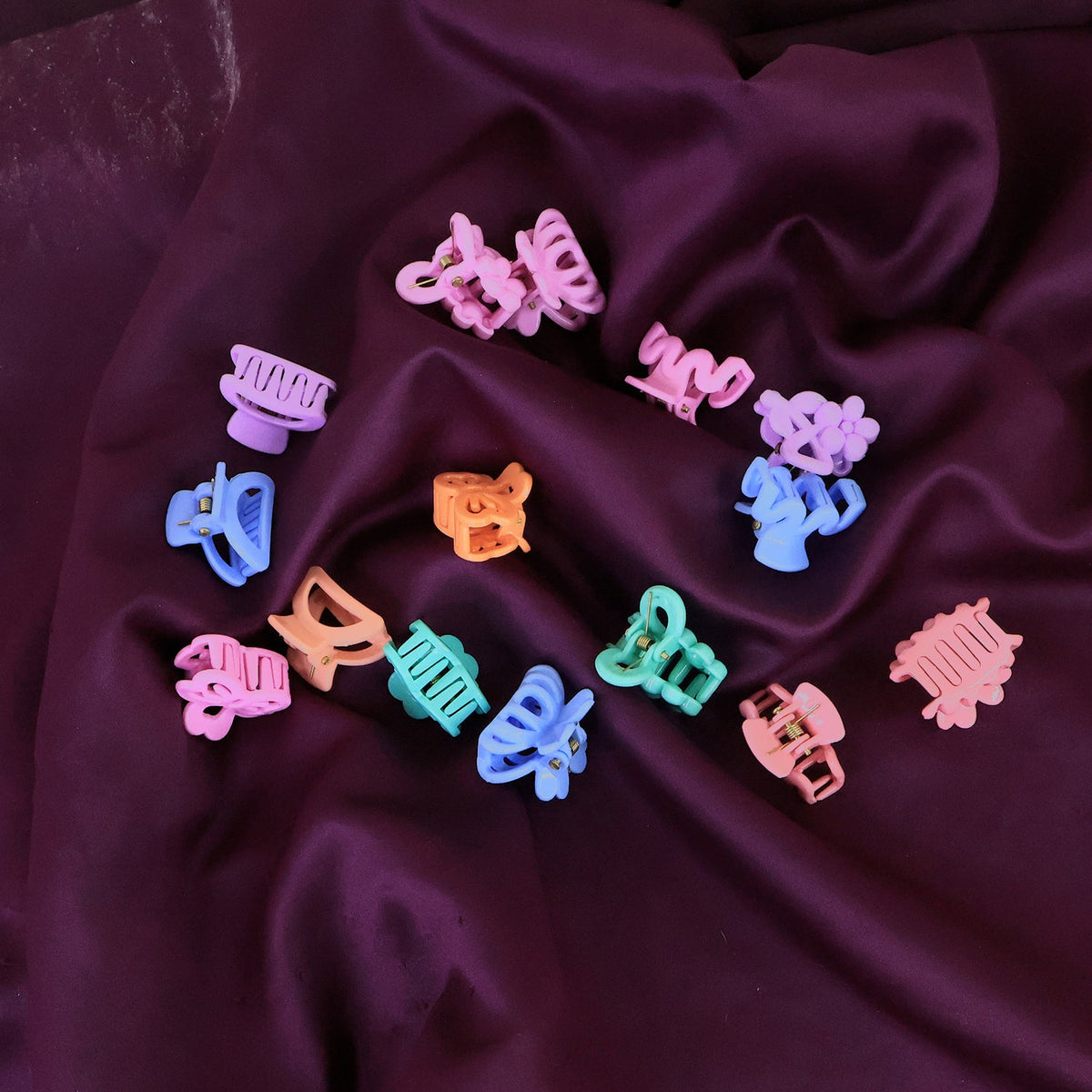 Brightly coloured mini hair clips for kids displayed neatly in a row.