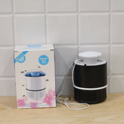A black and white Mosquito Killer Lamp next to its product box, both on a wooden surface against a white tiled wall.