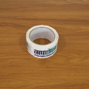 Applying printed packaging tape to seal a package, demonstrating its practicality for courier use.