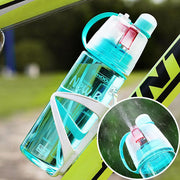 Hand holding the lightweight and portable 600ML spray water bottle.