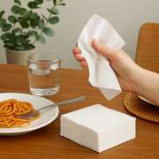 Disposable paper napkins stack for convenient single use.