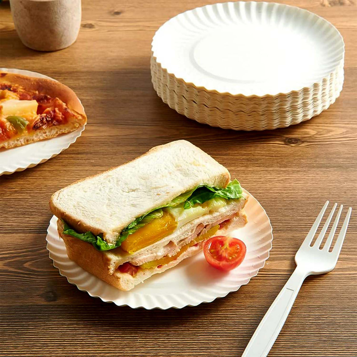 Top view of multiple nested Freshee eco-friendly 7 inch compostable paper plates.