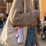Portable 450ML water bottle with decorative charm and hanging loop
