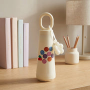Glass water bottle with smile design and cherry motif, perfect for daily hydration
