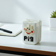 Close-up of pixel art pen holder storing stationery items neatly
