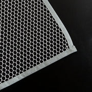 Hand holding the lightweight Large Ironing Press Net mesh protector cloth