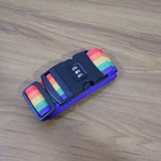 Rainbow Luggage Strap securing a black suitcase, making it easy to spot.