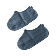 Two gray silicone foot protectors with textured soles are presented on a clean white background.