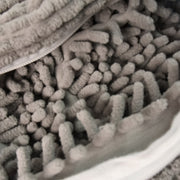 Reusable laundry bag holding a pair of sports shoes for washing
