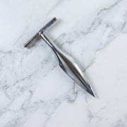 Stainless steel coconut breaker tool set displayed on a white background