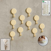 Set of 10 self adhesive round wall hooks arranged neatly for home organization